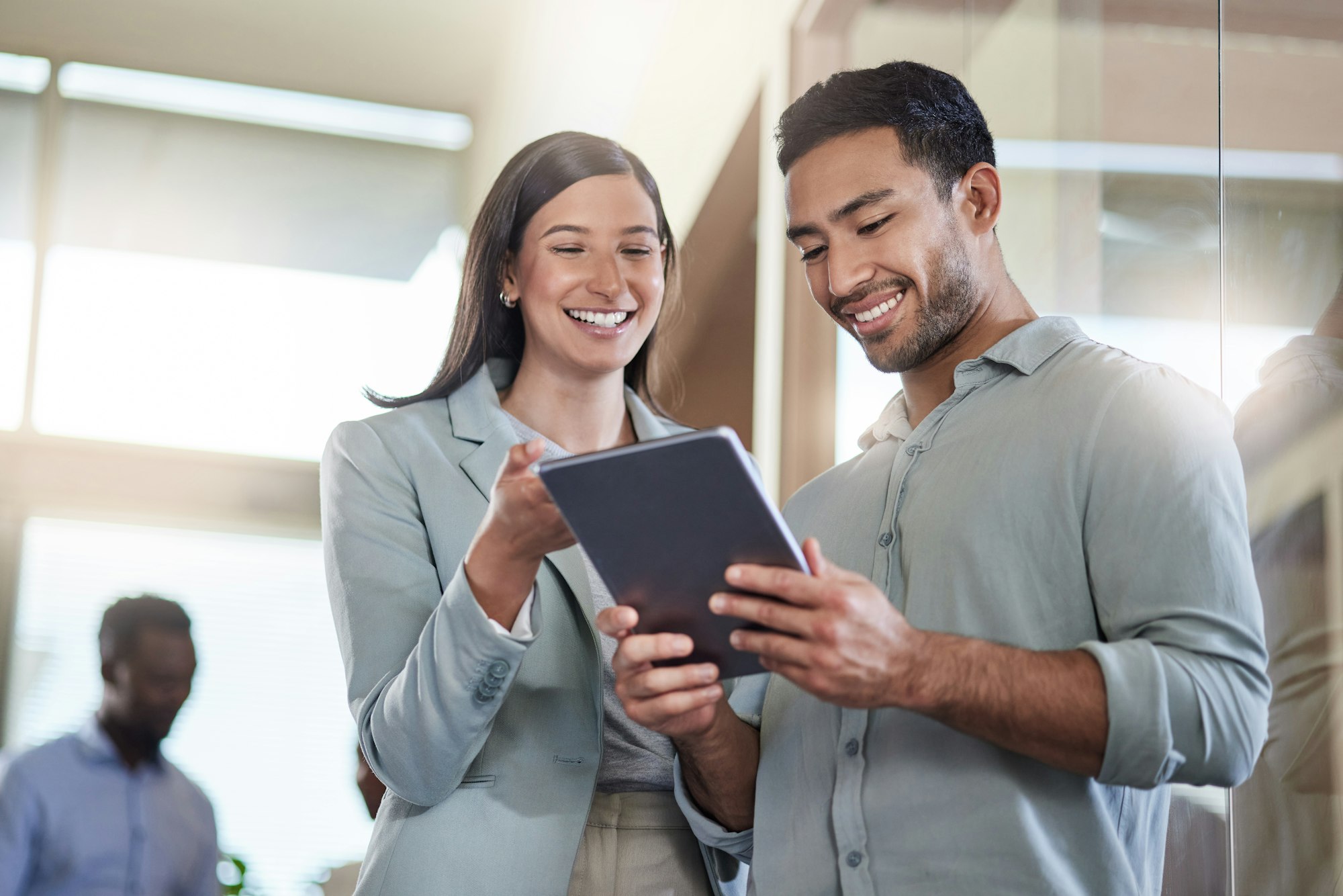 im so glad i found you shot of two coworkers talking while using a digital tablet